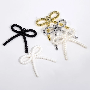 DIY acrylic bow pendants in matte black, gold, silver, and pearl white for jewelry making