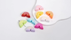 Flat lay of colorful rainbow acrylic charms for DIY jewelry and keychain accessories