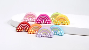 Detail of colorful rainbow acrylic beads with cloud accents for DIY craft accessories