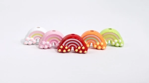 Flat lay of colorful acrylic rainbow charms with vertical holes for DIY jewelry making