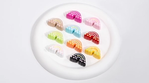 Macro shot of colorful acrylic rainbow charms with 3D embossed texture for DIY jewelry