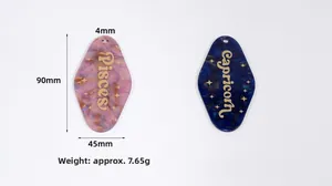 Detailed view of acrylic glitter zodiac pendants for Pisces and Capricorn with measurements