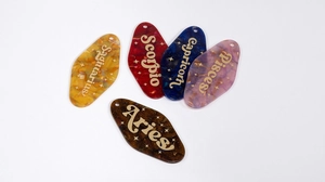 Macro view of colorful acrylic zodiac pendants with marble texture and glitter