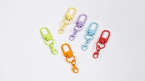 Detailed macro view of colorful lobster claw clasps in six macaron colors for DIY crafts