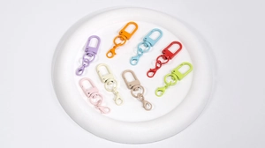 Close-up of candy-colored metal lobster clasps for DIY crafts in eight vibrant colors