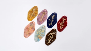 Various acrylic glitter zodiac motel keychains with gold constellation lettering
