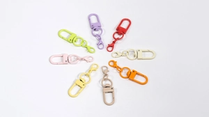Detailed macro shot of alloy lobster clasps in eight vibrant lacquered macaron colors