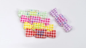 Detail of colorful acrylic candy charms with lucky text and star patterns for DIY crafts