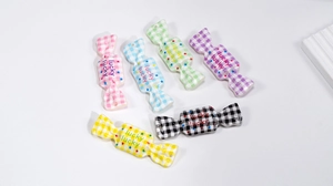 Macro shot of colorful checkered acrylic candy charms with Lucky print for DIY crafts