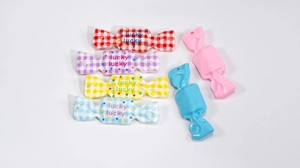 Flat lay of colorful acrylic candy charms with lucky pattern for DIY keychain making
