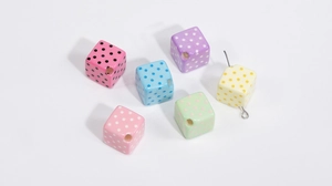 Close-up of colorful acrylic cube beads with polka dots for DIY jewelry making