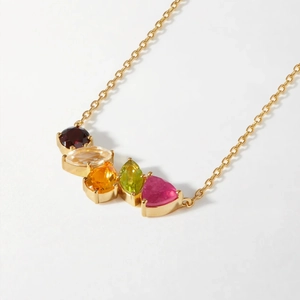 Macro shot of colorful cubic zirconia stones set in a gold-plated stainless steel necklace