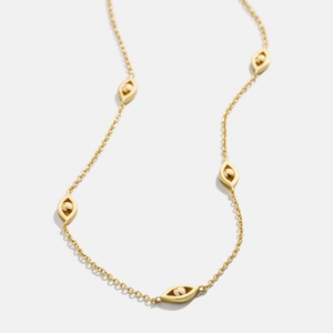 Collier minimaliste en acier titane doré orné de plusieurs breloques œil et de billes d'or