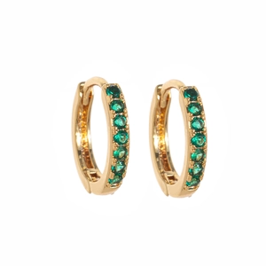 Close-up of gold-plated hoop earrings featuring a row of inlaid green zircon stones