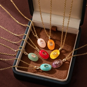 Close-up of seven assorted teardrop stone necklaces in a brown velvet jewelry gift box