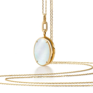 Detail of oval mother of pearl pendant necklace with gold chain and four-prong setting