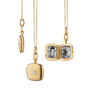 Detail of square 18K gold locket pendant showing photo slots and polished metal surface