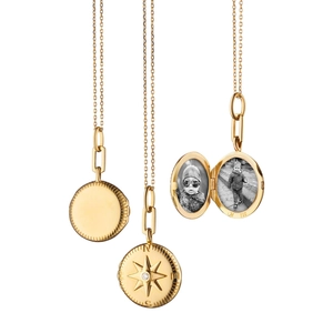 Detail of 18K gold locket showing internal photo holder and compass star pendant with diamond