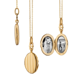 Macro detail of 18K gold oval locket pendant showing striped texture and photo slot