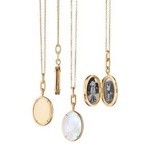 Macro view of 18K gold oval locket pendant showing interior photo space and 750 hallmark