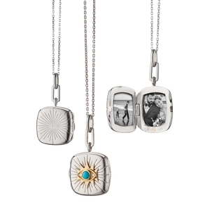 Detail view of square silver photo locket with evil eye design and turquoise stone