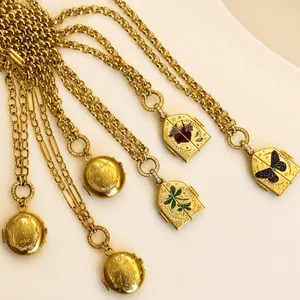 Vintage gold necklaces with enamel butterfly and heart pendants on marble background
