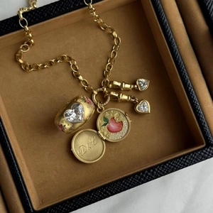 Detail of vintage locket with D&G engraving and heart stones on chunky chain