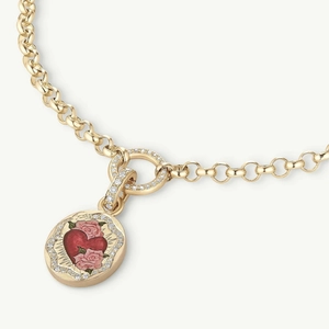 Detail of 18K gold plated oval pendant with red heart, pink rose and zircon border