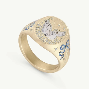 Detailed close-up of 14K gold signet ring with hand-painted enamel bird and star motif