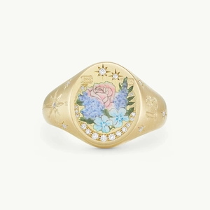 Detailed macro of vintage seal ring featuring floral enamel and number 13 engraving