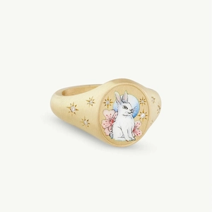 Detail of gold signet ring with hand-painted enamel rabbit and star-set white crystals