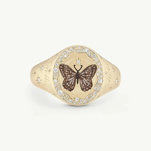 Detail of 18K gold-plated signet ring featuring a butterfly and star-set diamond