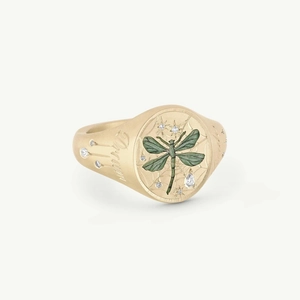 Detail of matte gold signet ring with green dragonfly motif and Dream engraving