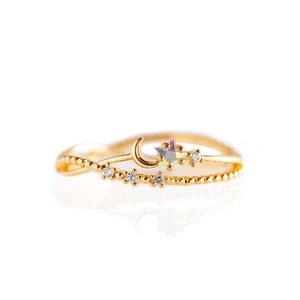 Elegant gold celestial ring with polished crescent moon and iridescent star crystals