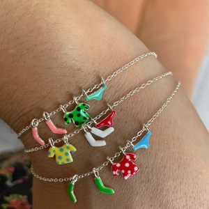 Detail showing silver chains with colorful enamel shirt, sock and underwear charms