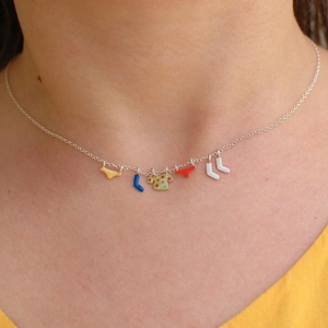 Fashionable silver chain necklace with colorful enamel laundry charms on a female model