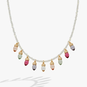 Dettaglio della collana di perline boho con ciondoli in vetro colorato e cappucci dorati
