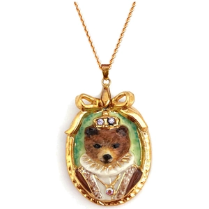 Vintage gold necklace with a royal bear pendant and purple gemstone crown details