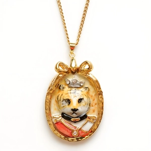 Vintage gold necklace featuring a royal tiger portrait pendant with a bow detail