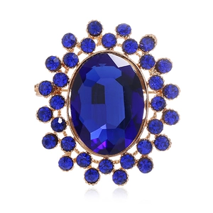 Broche de luxe vintage avec cristal bleu ovale et base en alliage doré poli