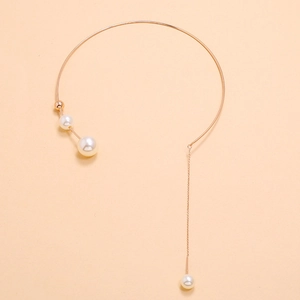 Minimalist gold choker necklace featuring elegant white pearls and a delicate tassel chain