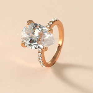 Luxurious pear cut diamond ring in rose gold finish with pave setting accents