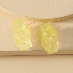 Minimalist geometric yellow resin stud earrings with S925 silver needles on neutral stand