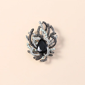 Vintage style brooch with pear-cut black gemstone and crystal encrusted coral design