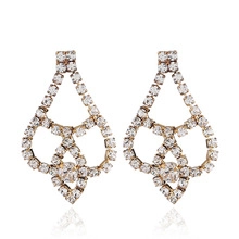 Detail view of long tassel geometric drop earrings with sparkling rhinestones and gold plating