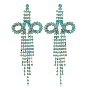 Detail of long tassel earrings with blue rhinestones and gold-tone finish chains