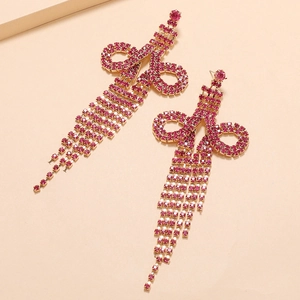 Detail of rose red rhinestone fringe earrings with long cascading tassels in golden finish