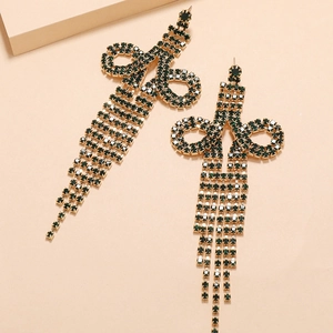 Detailed close-up of emerald green rhinestone long tassel earrings with golden chain base