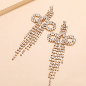 Detail showing elegant long silver tassel earrings with sparkling rhinestone crystals