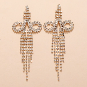 Detailed close-up of luxury gold-plated long tassel earrings with sparkling rhinestones